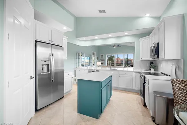 a kitchen with cabinets and stainless steel appliances