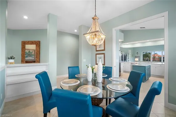 a view of a dining room with furniture and a chandelier