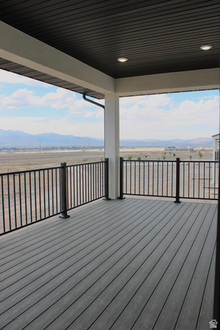2613 Scarlet Road, Unit 258 Eagle Mountain, UT 84005 - Photo 29 of 32 Covered outdoor deck with grey composite decking, black metal railings, and recessed ceiling lighting