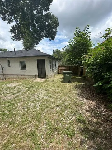 a backyard of a house with table and chairs