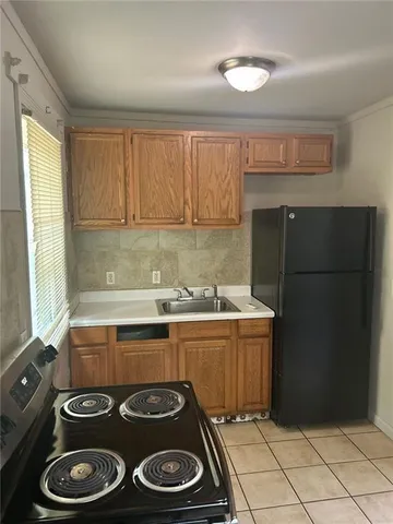 a kitchen with a stove and a refrigerator