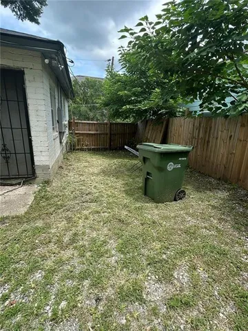a backyard of a house with barbeque oven and outdoor seating