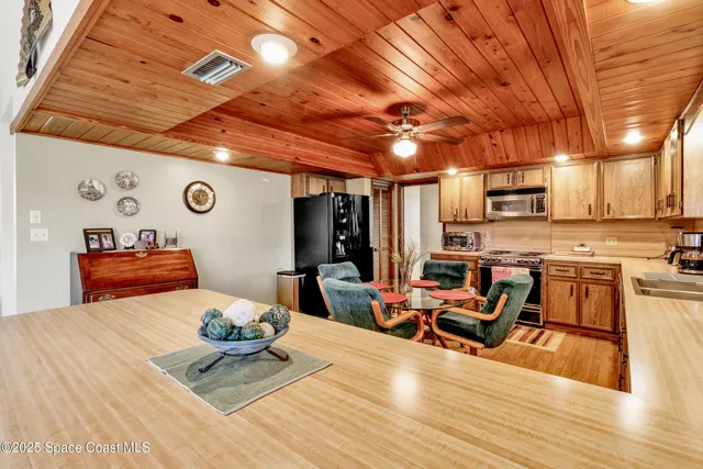 a living room with lots of furniture and kitchen view