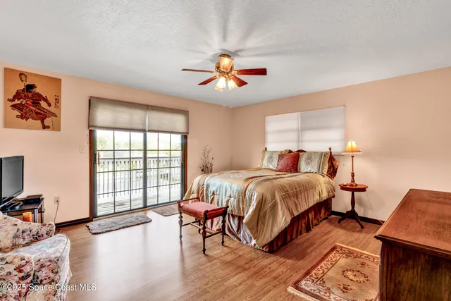 a bedroom with bed and wooden floor