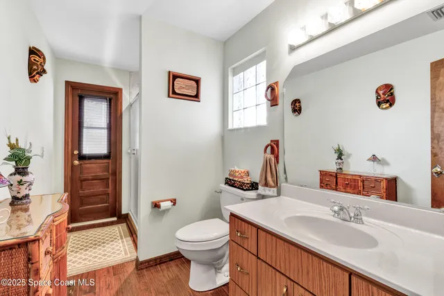 a bathroom with a sink a toilet and shower curtain