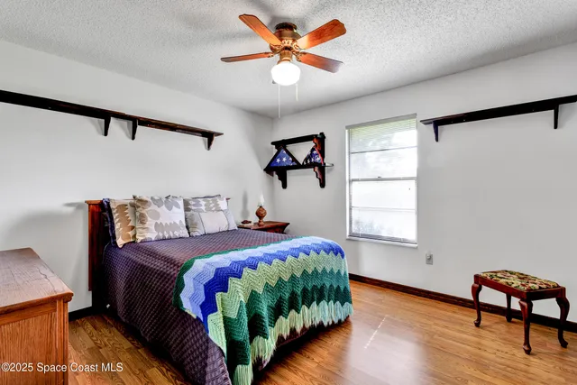 a bedroom with bed and a window