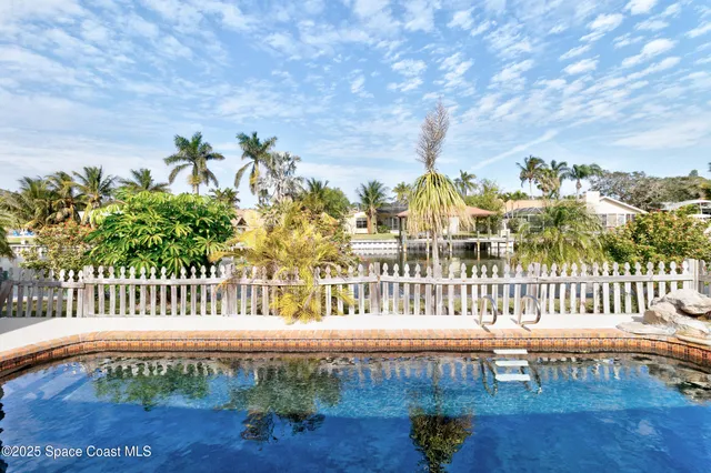 a view of a chair and table in backyard
