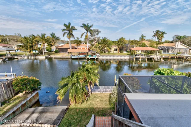 an aerial view of a house with a lake view