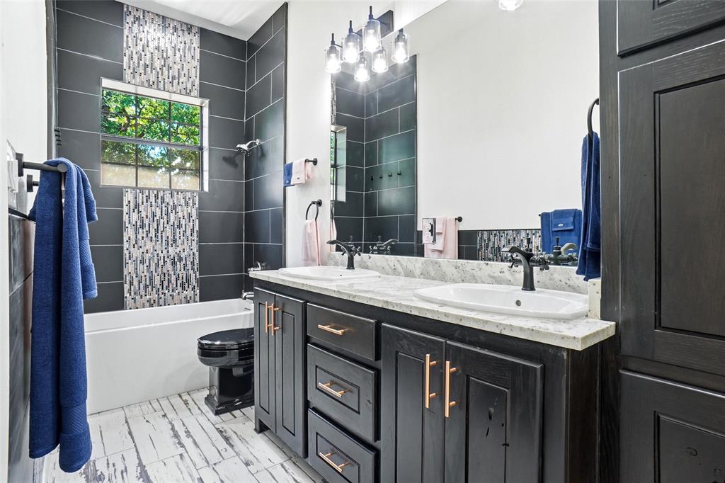 13240 Briar Road Azle, TX 76020 - Photo 17 of 39 a bathroom with a sink a vanity and a mirror