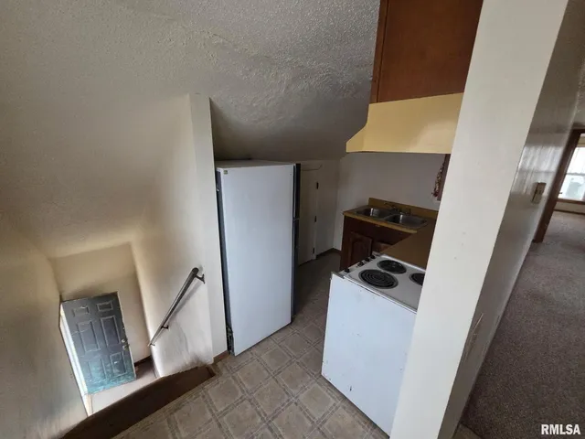 a view of storage and utility room with refrigerator