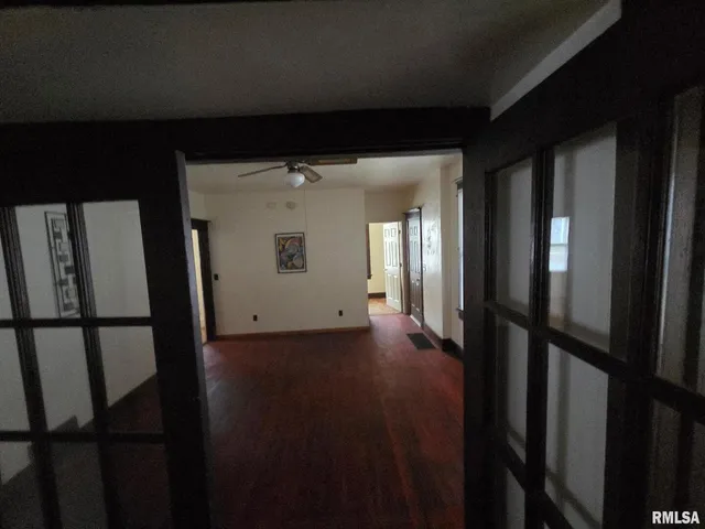 a view of a hallway with wooden floor
