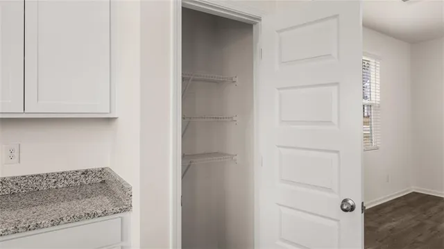 a kitchen with wooden floors and white appliances