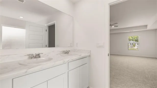a white bath tub sitting next to a white sink