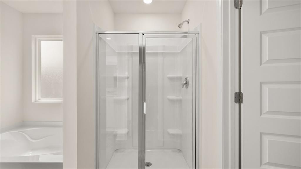 307 Friendship Oak Way Hampton, GA 30228 - Photo 22 of 35 a bathroom with a glass shower door