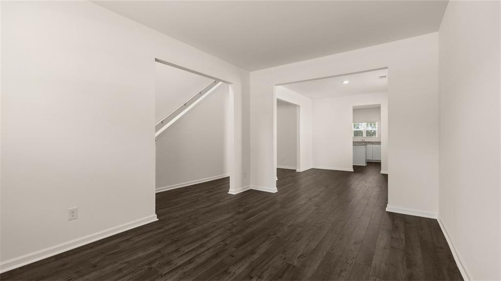 307 Friendship Oak Way Hampton, GA 30228 - Photo 4 of 35 an empty room with wooden floor and windows
