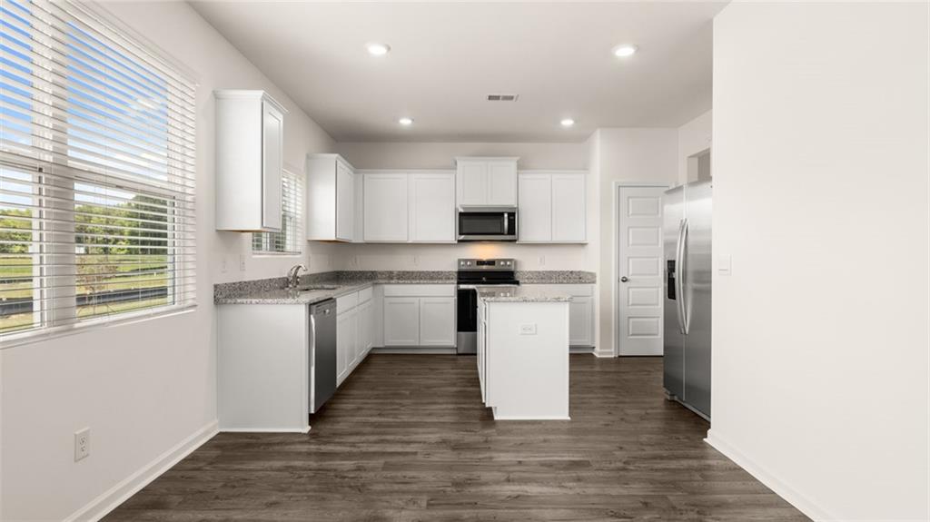 307 Friendship Oak Way Hampton, GA 30228 - Photo 7 of 35 a kitchen with white cabinets and white appliances