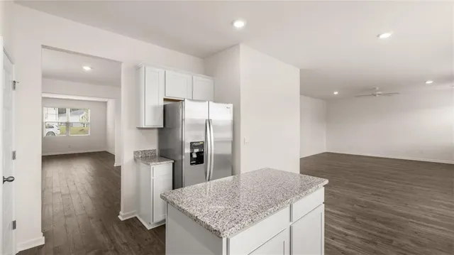 a kitchen with granite countertop a sink and a window