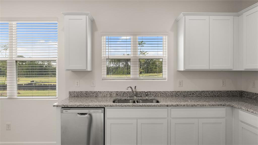 307 Friendship Oak Way Hampton, GA 30228 - Photo 10 of 35 a kitchen with granite countertop a sink and a window