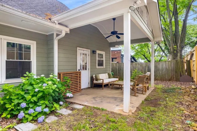 a view of a patio with table and chairs and potted plants