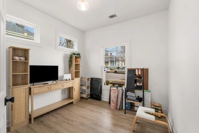 a view of a livingroom with furniture and a flat screen tv