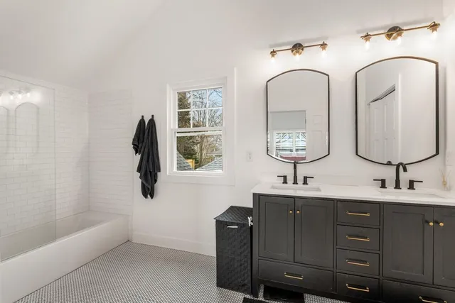 a bathroom with 2 sink and a mirror