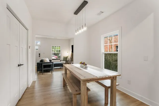 a view of a dining room with furniture window and wooden floor