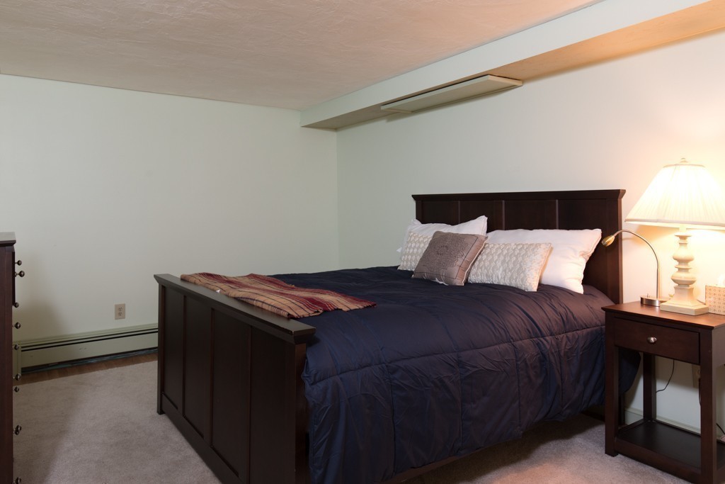 6 Popes Lane Hingham, MA 02043 - Photo 21 of 29 a bed sitting in a bedroom next to a lamp