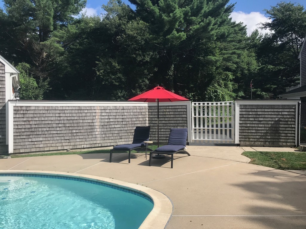 6 Popes Lane Hingham, MA 02043 - Photo 24 of 29 a backyard of a house with table and chairs