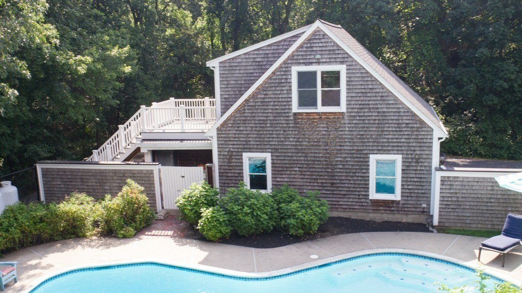 6 Popes Lane Hingham, MA 02043 - Photo 8 of 29 a view of a house with brick walls and a yard with plants