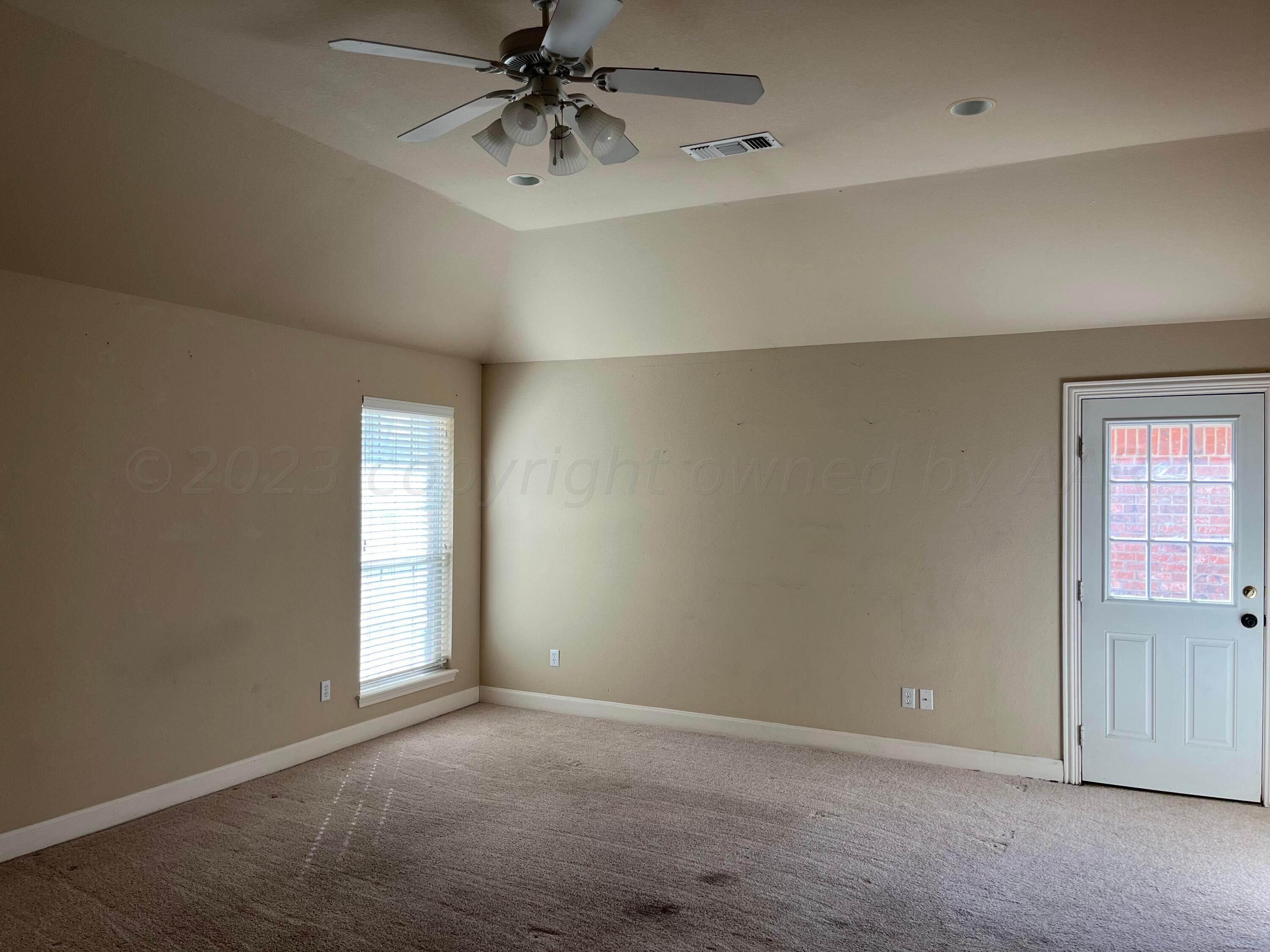 2 Windtree Amarillo, TX 79121 - Photo 3 of 15 an empty room with a window and a chandelier fan