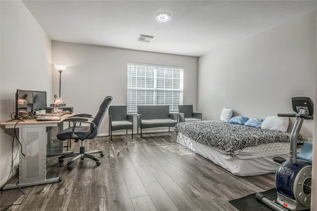a view of workspace with wooden floor and windows