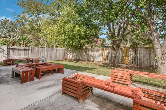 a backyard of a house with table and chairs