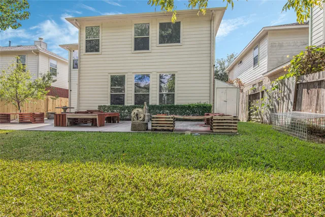 a view of a house with a patio and a yard