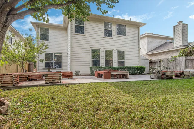 a view of a house with backyard and sitting area