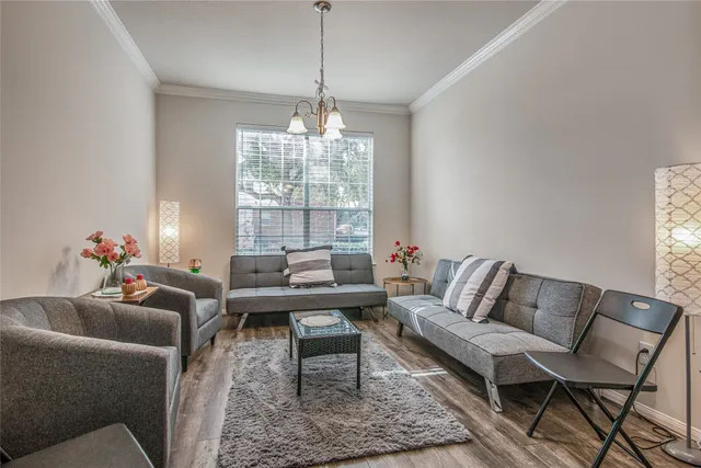 a living room with furniture and a chandelier