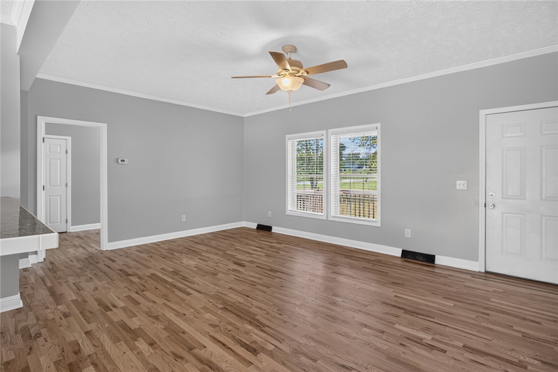 564 Fairfield Road Walhalla, SC 29691 - Photo 9 of 50 Gleaming hardwood floors anchor this open living area highlighted by clean crown molding.