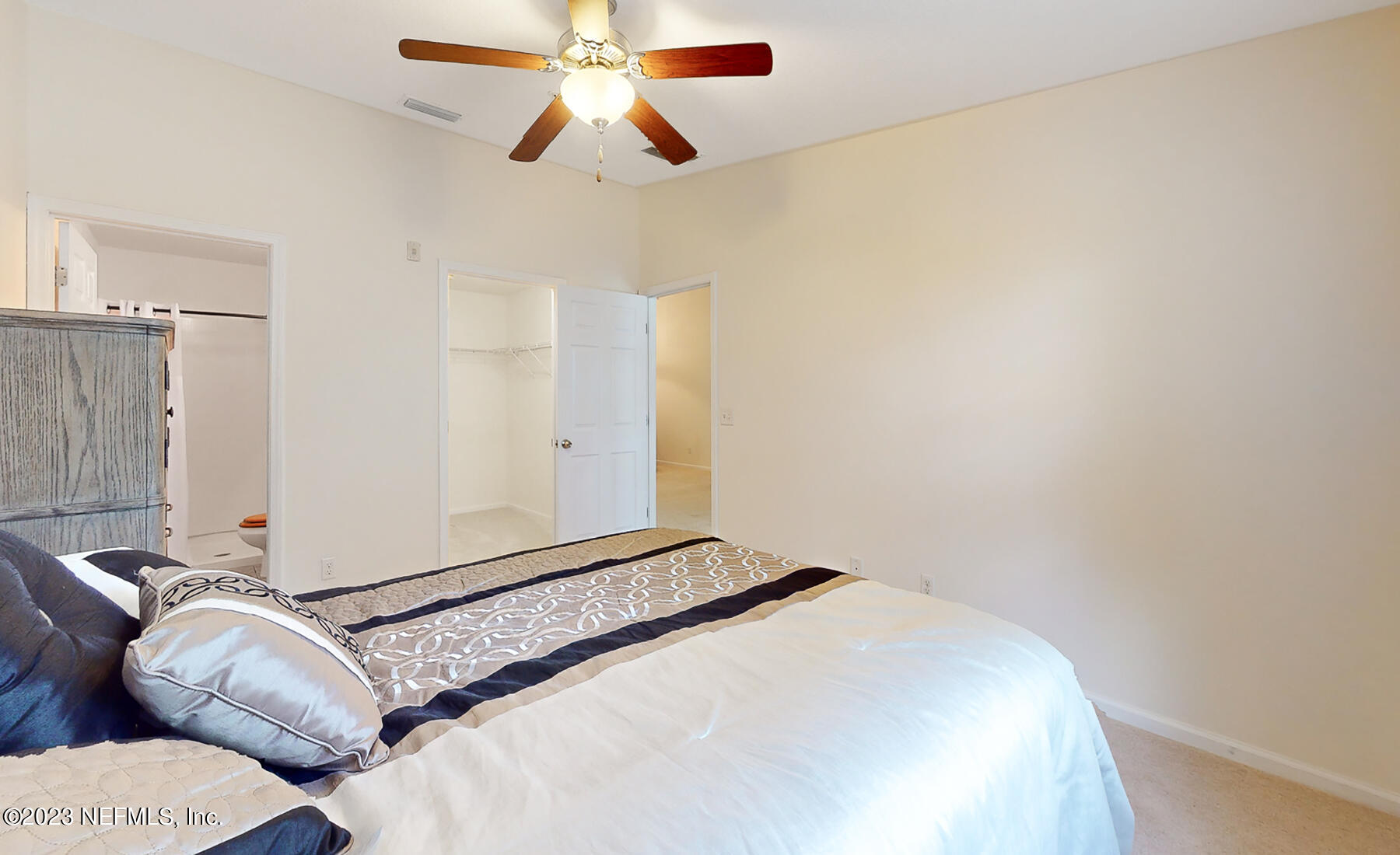 303 Golden Lake Loop St. Augustine, FL 32084 - Photo 16 of 38 a bedroom with a bed and a chandelier