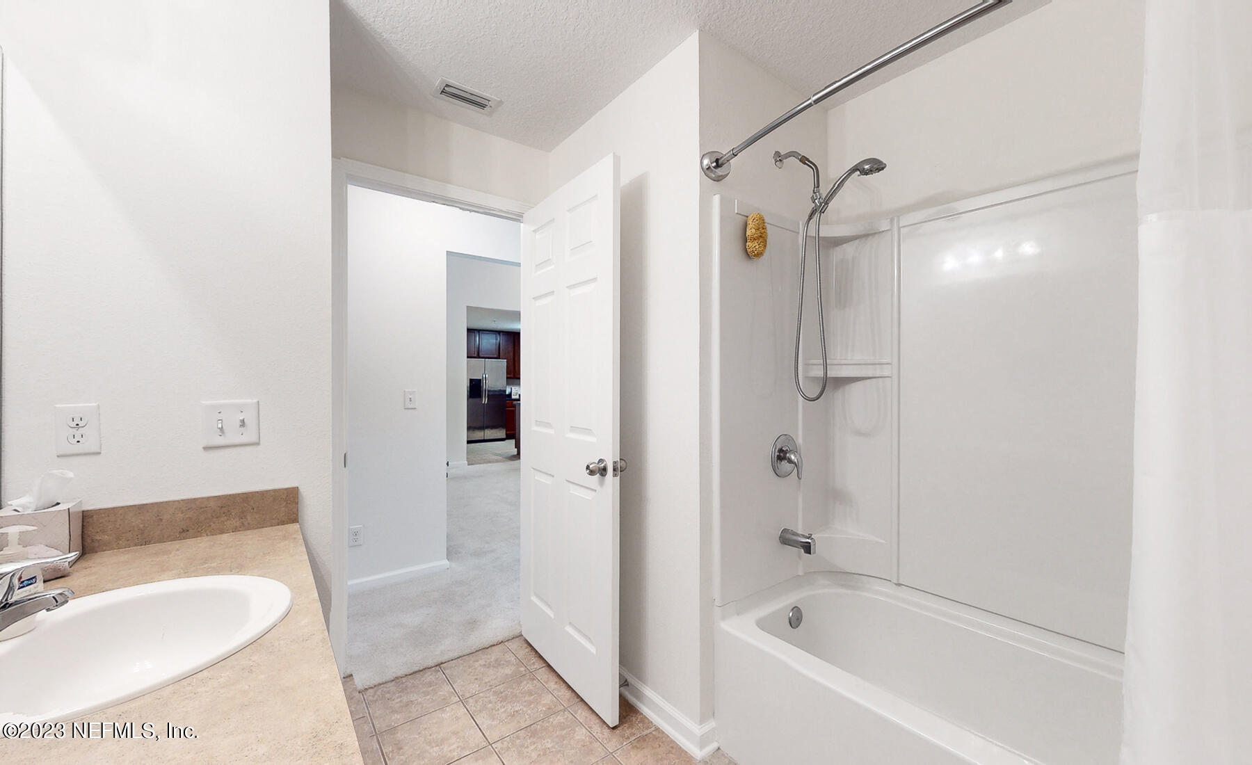 303 Golden Lake Loop St. Augustine, FL 32084 - Photo 20 of 38 a bathroom with a tub shower sink and vanity