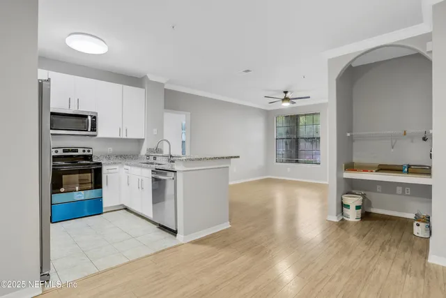 a kitchen with a sink appliances and cabinets