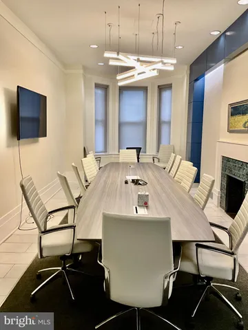 a view of a dining room with furniture and a chandelier