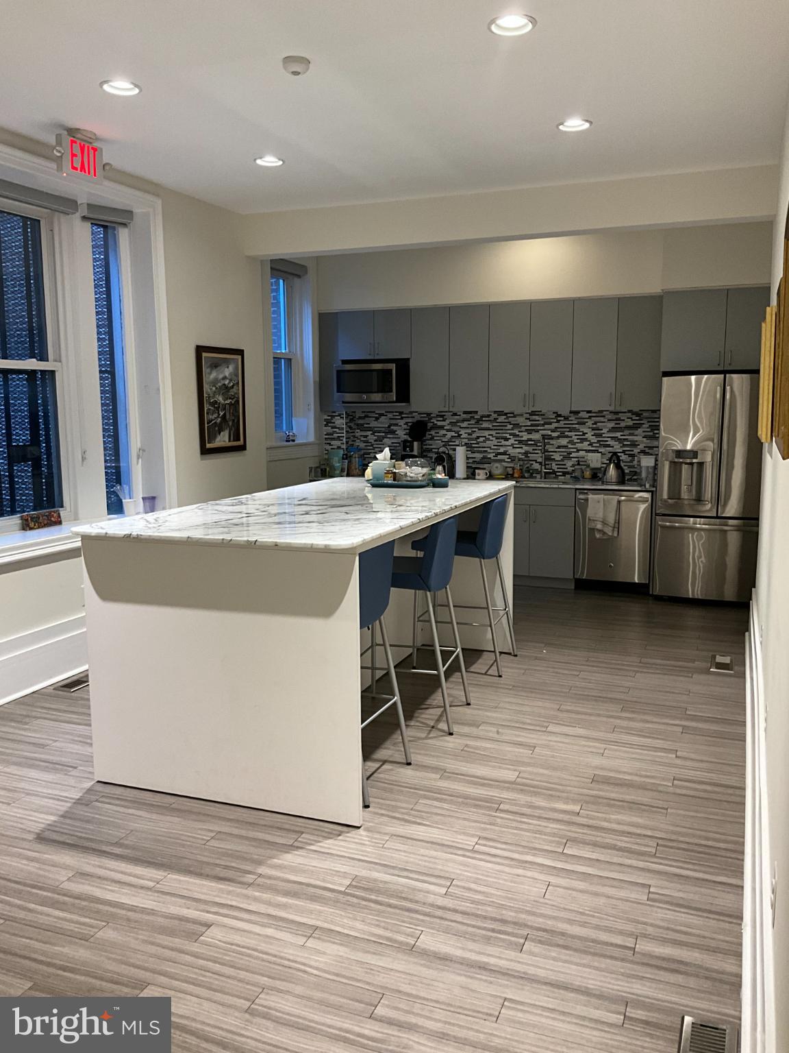 1230 17th Street Northwest Washington, DC 20036 - Photo 3 of 12 a kitchen with stainless steel appliances a stove a sink cabinets and a wooden floor