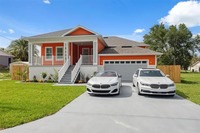 a front view of a house with a garden
