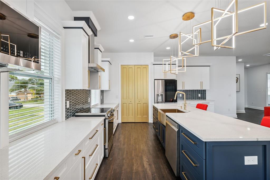 8605 Inwood Drive Hudson, FL 34667 - Photo 14 of 65 a kitchen with a stove a sink and a refrigerator