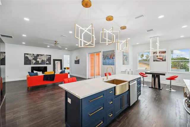 a living room with furniture and kitchen view