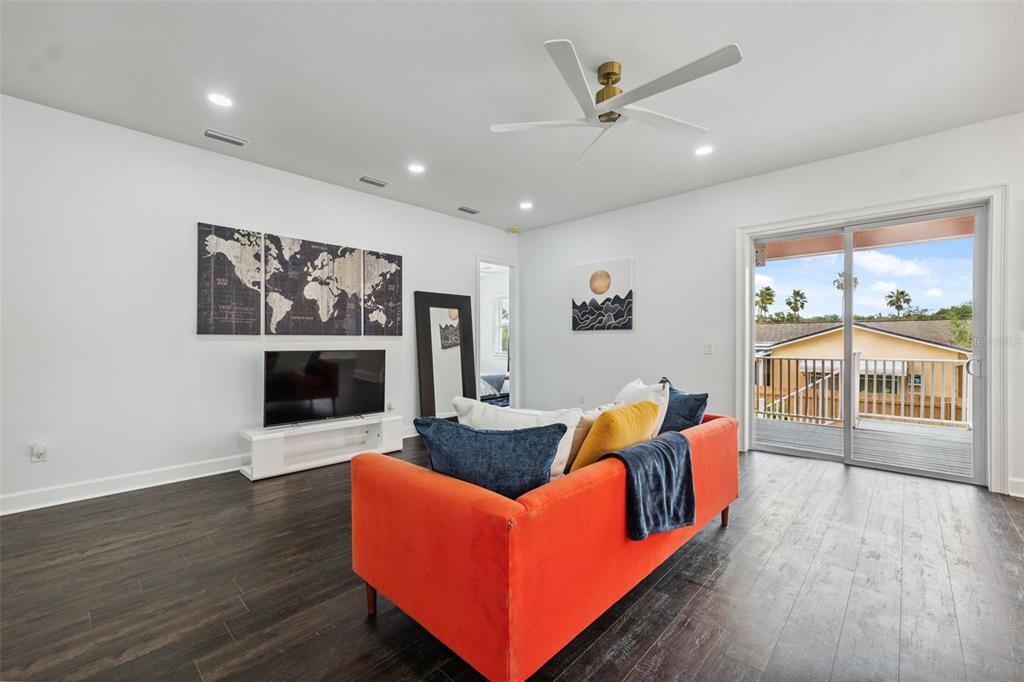 8605 Inwood Drive Hudson, FL 34667 - Photo 19 of 65 a living room with furniture a fireplace and a floor to ceiling window