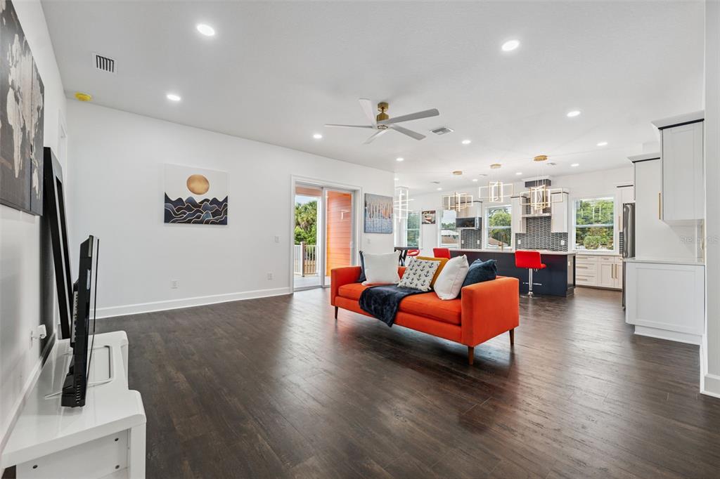 8605 Inwood Drive Hudson, FL 34667 - Photo 21 of 65 a living room with furniture kitchen view and a wooden floor