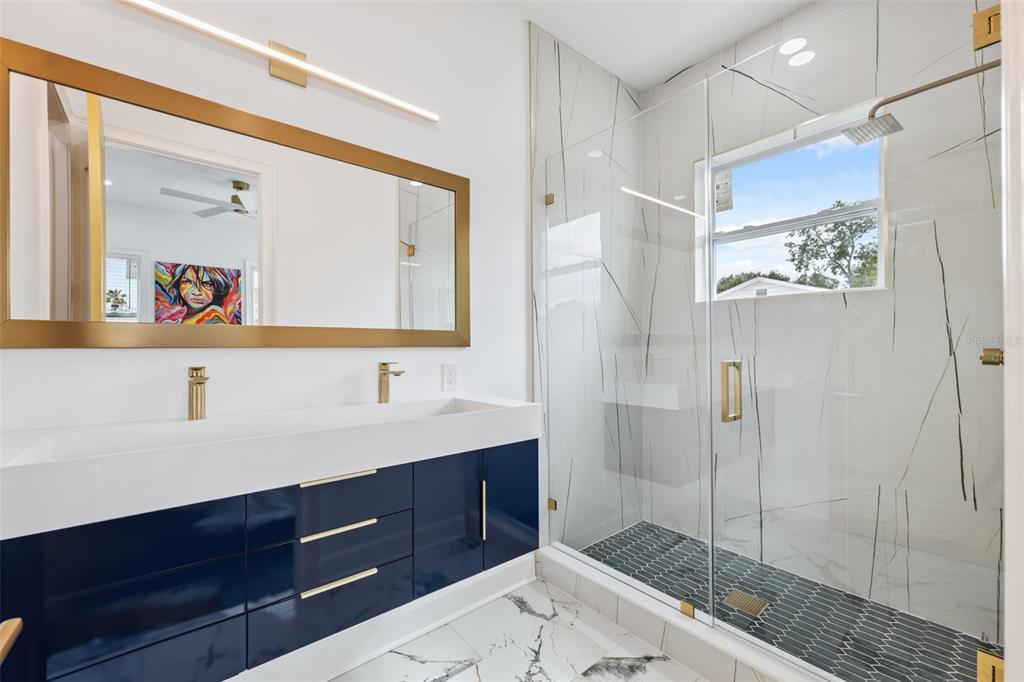 8605 Inwood Drive Hudson, FL 34667 - Photo 27 of 65 a bathroom with a shower sink and mirror