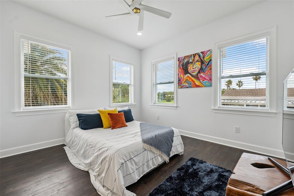 8605 Inwood Drive Hudson, FL 34667 - Photo 35 of 65 a bedroom with a bed and wooden floor