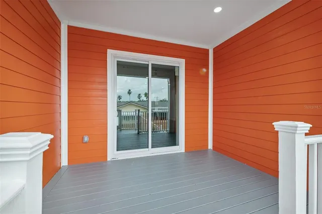 a backyard of a house with plants and wooden fence