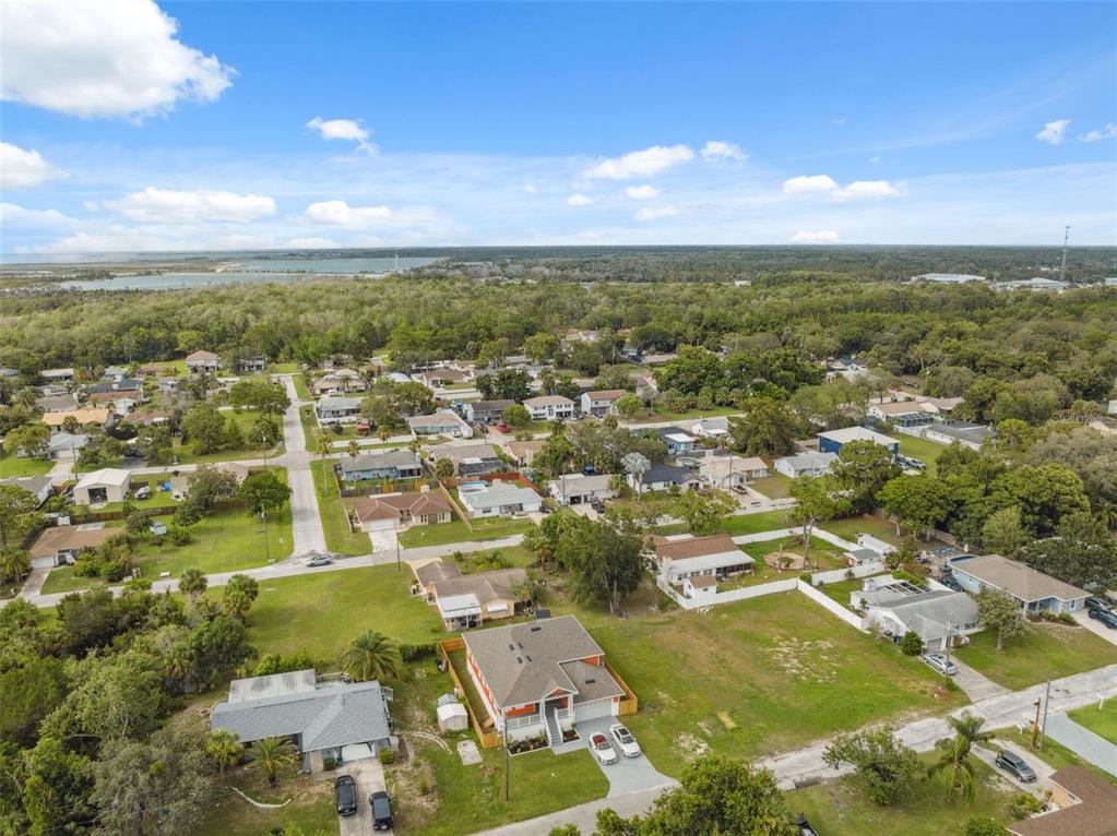 8605 Inwood Drive Hudson, FL 34667 - Photo 49 of 65 an aerial view of residential houses with outdoor space and trees